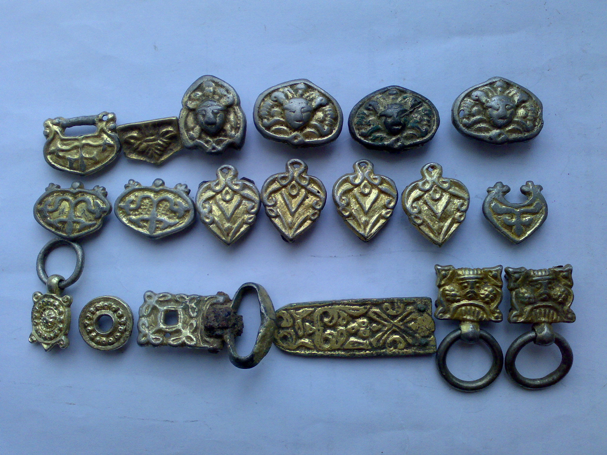 silver gilt belt fittings with faces and floral ornaments